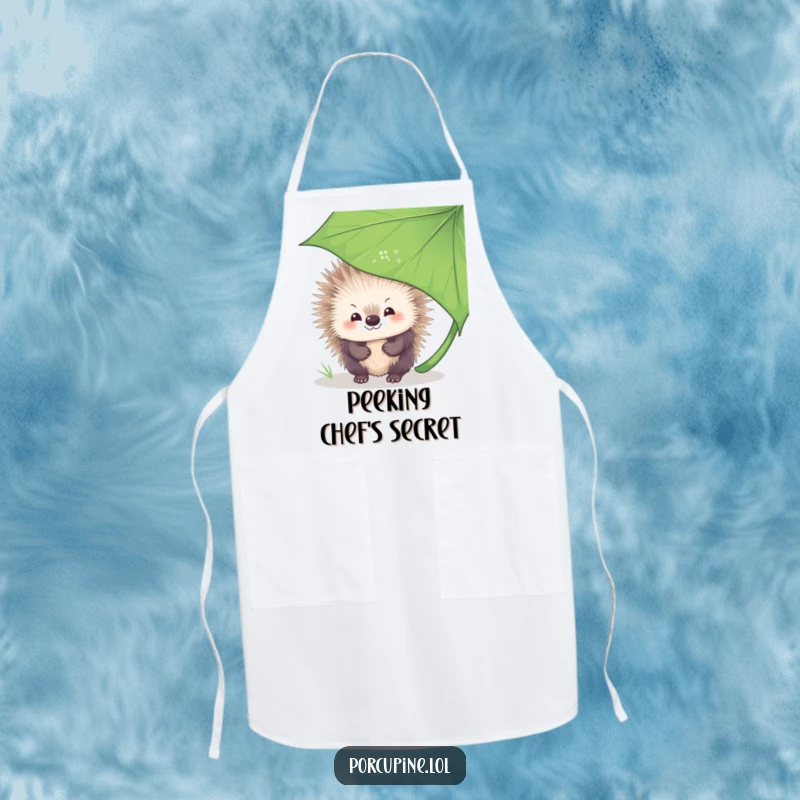 Funny Apron showing a porcupine with a shy smile, peeking playfully from behind a large leaf, bringing a touch of sweetness to cooking.