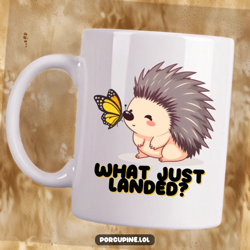 Funny porcupine mug showing a porcupine with wide eyes looking surprised as a tiny butterfly lands on it.