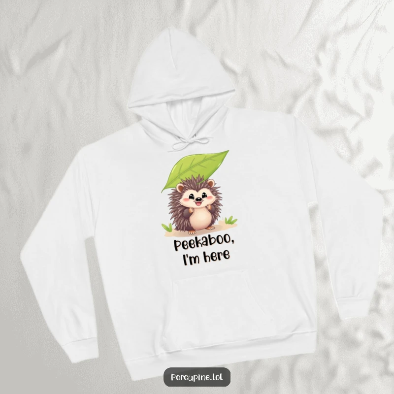 Funny hoodie with a porcupine peeking from behind a leaf with a grin, offering cozy comfort and a generous dose of playful humor.