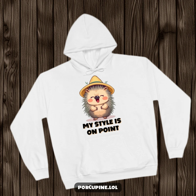 Funny hoodie showcasing a porcupine balancing a straw hat and giggling, perfect for cozying up with a smile.