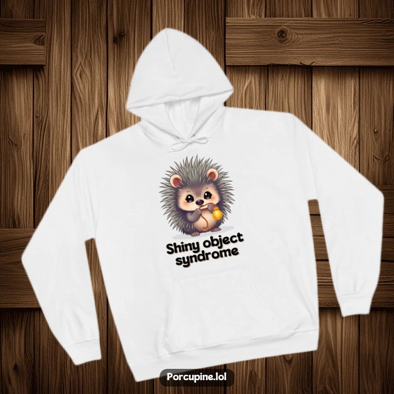Funny hoodie featuring a porcupine with sparkling, focused eyes, playfully batting at a dangling string, radiating energetic fun.
