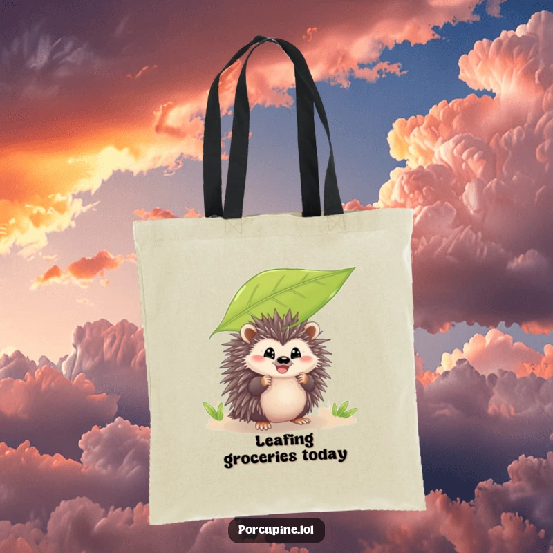 Funny tote bag featuring a porcupine peeking from behind a leaf with a grin, perfect for carrying essentials with a playful and humorous touch.