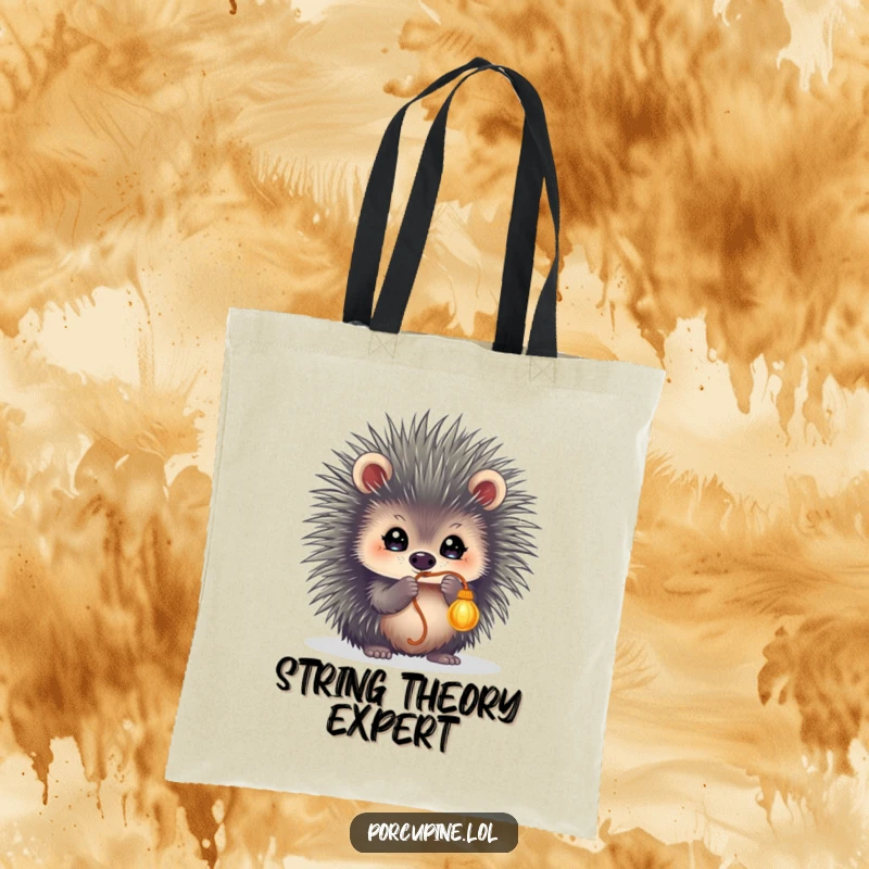 Funny tote bag depicting a porcupine with sparkling eyes, energetically batting at a dangling string, perfect for carrying with playful flair.